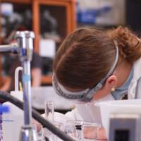 individual is writing down notes